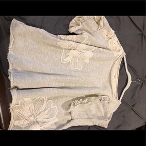 Cream top with floral appliqué